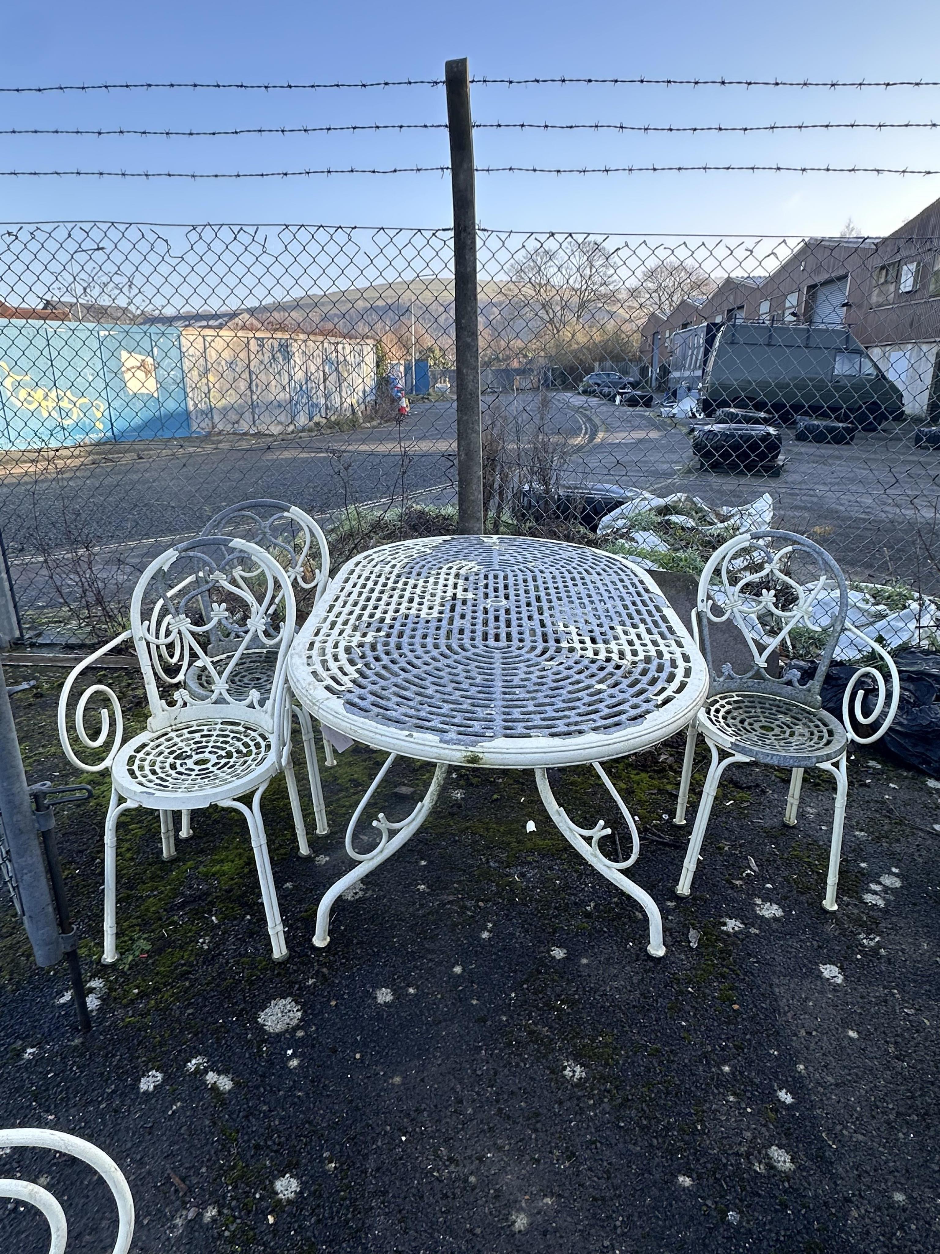 An aluminium garden table, width 150cm, depth 96cm, height 71cm, three chairs and a bench. Condition - poor